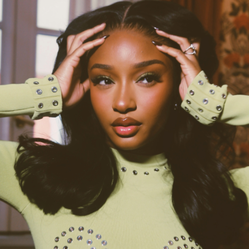 picture of Ayra Starr wearing a jade green bejewelled  top