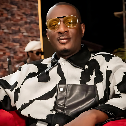 Picture of ID Cabasa in medicated glasses and wearing a zebra patterned top.