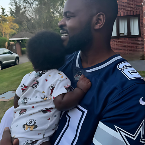 Picture Of Afrobeats Singer Falz holding his child