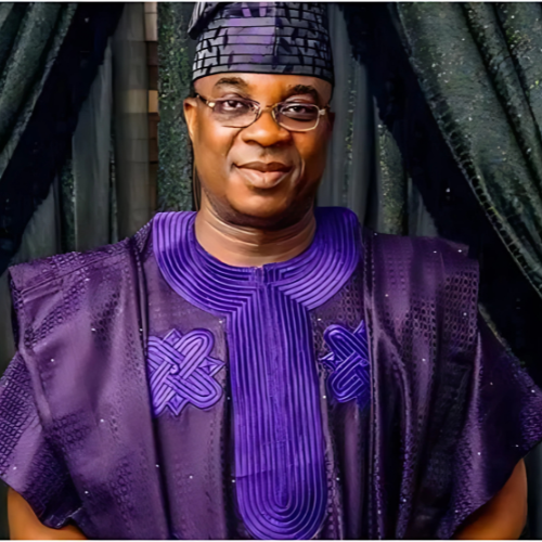 Image of KWAM 1 wearing a purple Yoruba traditional attire