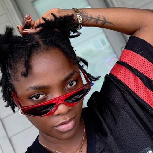 Picture of Simi from instagram. She's posing in a black and red casual jersey top