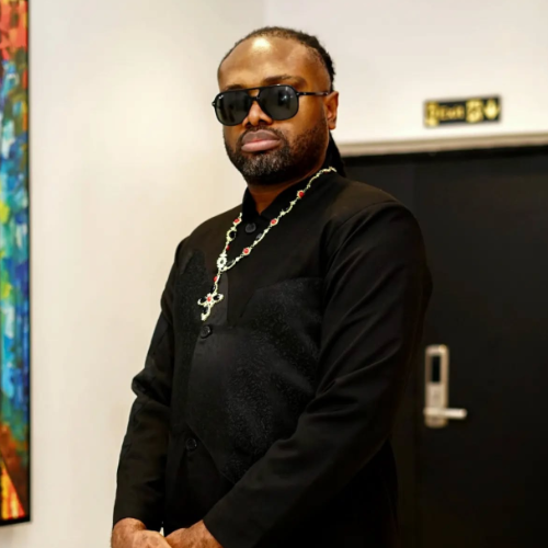 Picture of Cobhams in black outfit and Cross chain necklace